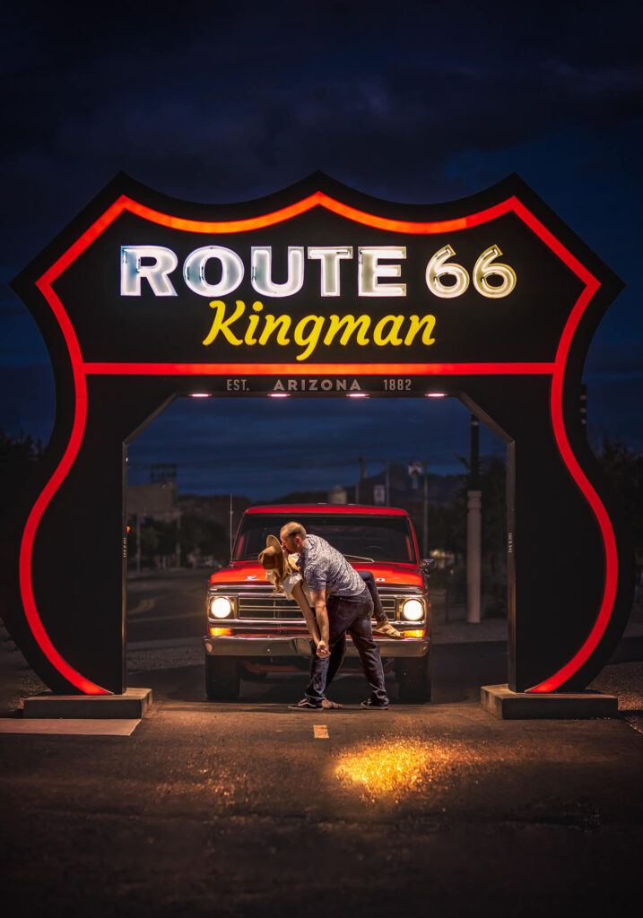 Engagement session in front on Kingman Route 66 sign. Nostalgic.